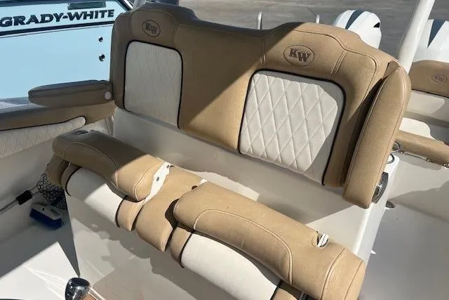 Slide: The Image of 2018 Key West 263 FS boat interior with tan and white cushioned seating. - 5
