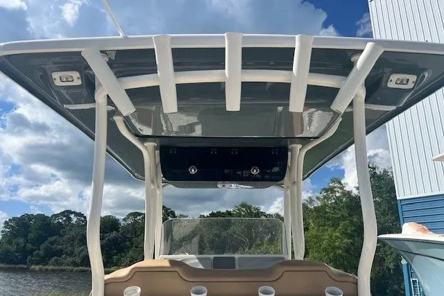Slide: The Image of 2018 Key West 263 FS boat with T-top, docked under blue sky. - 8