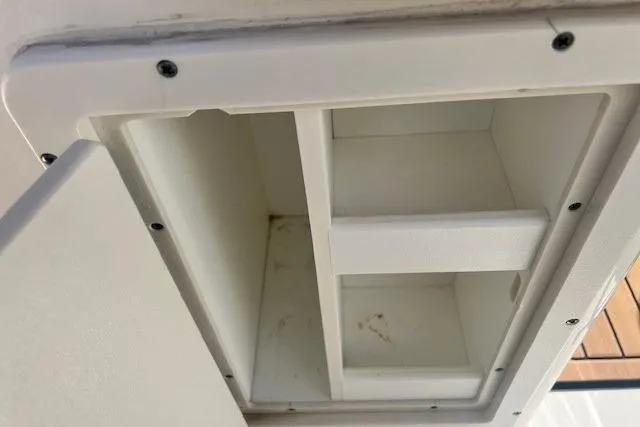 Slide: The Image of Storage compartment on a 2018 Key West 263 FS boat, featuring a white interior. - 9