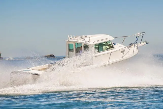 Slide: The Image of Manufacturer Provided Image: 2025 Parker 2520 XLD Sport Cabin boat cruising on the water. - 0