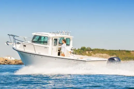 Slide: The Image of Manufacturer Provided Image: 2025 Parker 2520 XLD Sport Cabin boat cruising on water. - 1