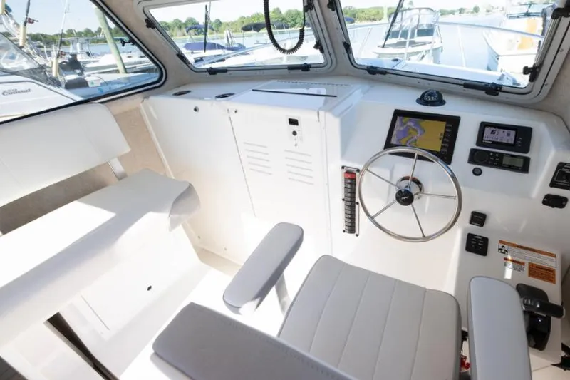 Slide: The Image of Manufacturer Provided Image: Interior of 2025 Parker 2520 XLD Sport Cabin boat with steering wheel and navigation system. - 9