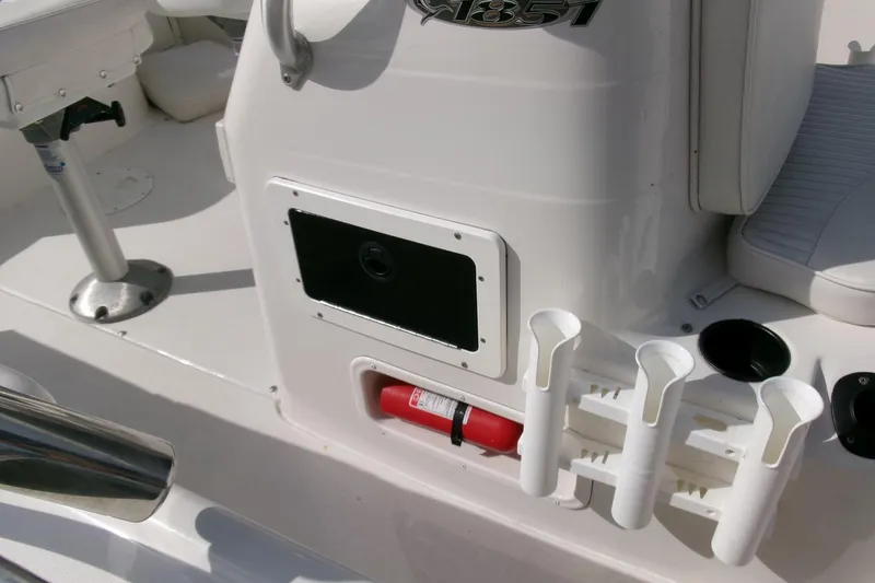 Slide: The Image of 2005 Seaswirl 1851 CC O/B boat interior with rod holders and fire extinguisher. - 13