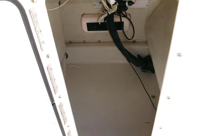 Slide: The Image of 2005 Seaswirl 1851 CC O/B boat interior compartment with wiring and fittings. - 14