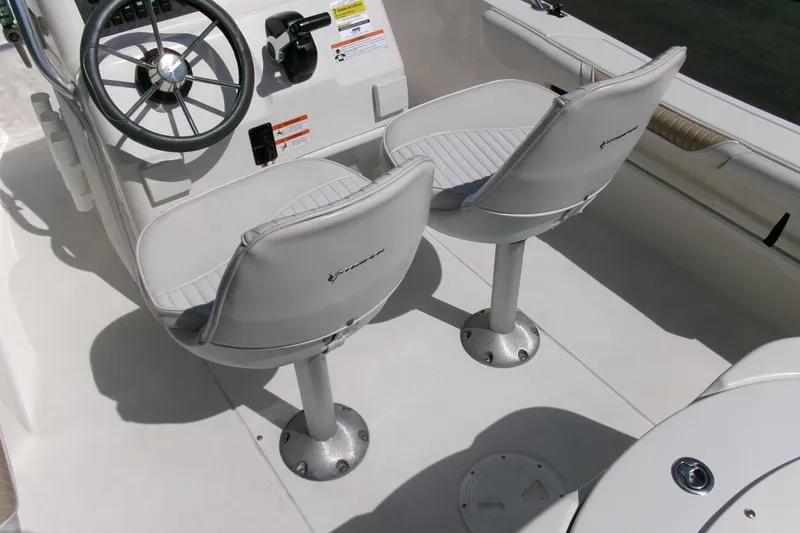 Slide: The Image of 2005 Seaswirl 1851 CC O/B boat interior with steering wheel and two seats. - 19
