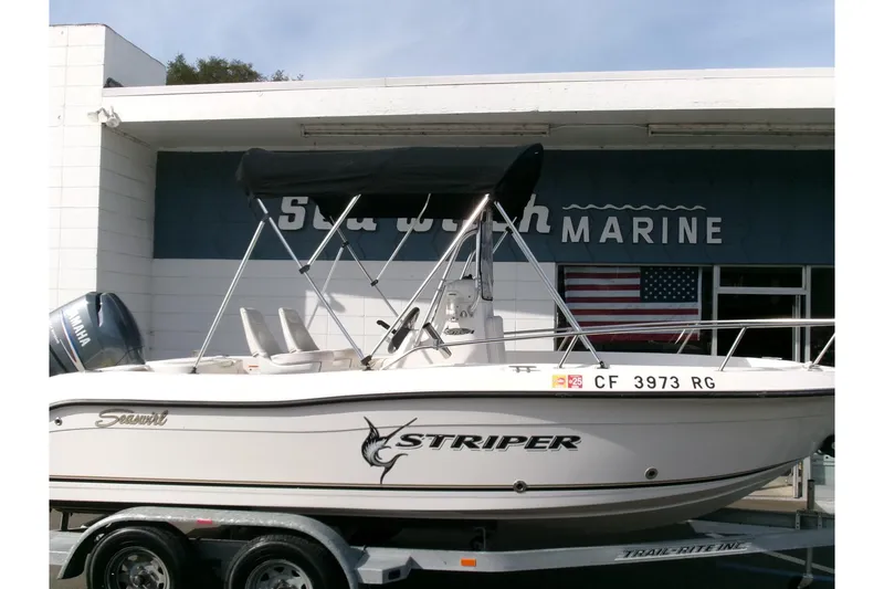 Slide: The Image of 2005 Seaswirl 1851 CC O/B boat on trailer, displayed at marine dealership. - 24