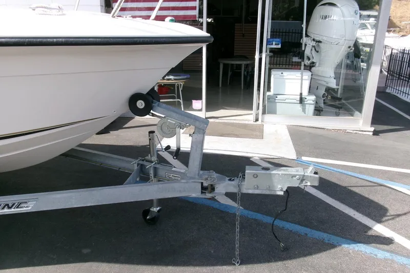 Slide: The Image of 2005 Seaswirl 1851 CC O/B boat on trailer, parked near a showroom. - 27