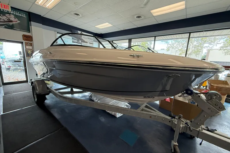 The Image of 2025 Bayliner VR4 Bowrider OB displayed indoors on a trailer. - 0