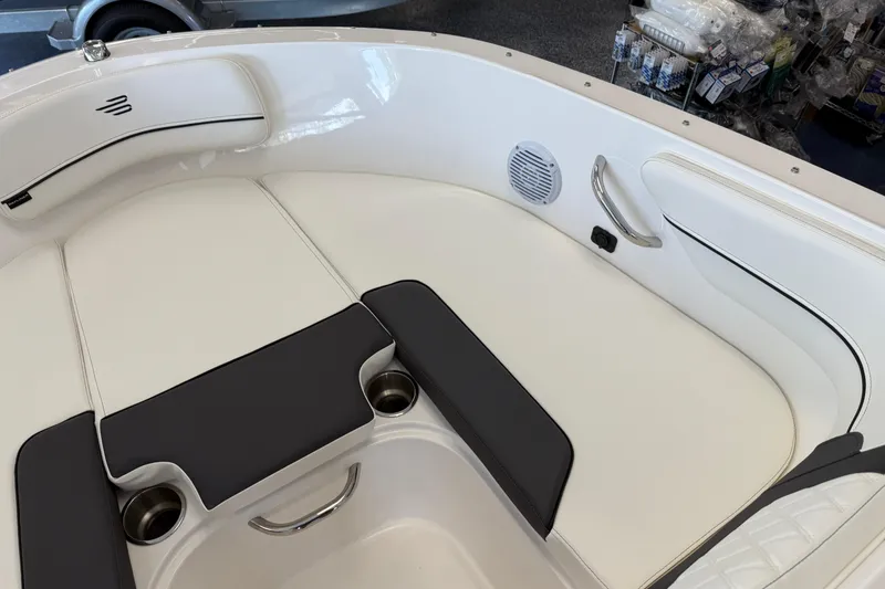 Slide: The Image of 2025 Bayliner VR4 Bowrider OB interior with white seating and cup holders. - 10