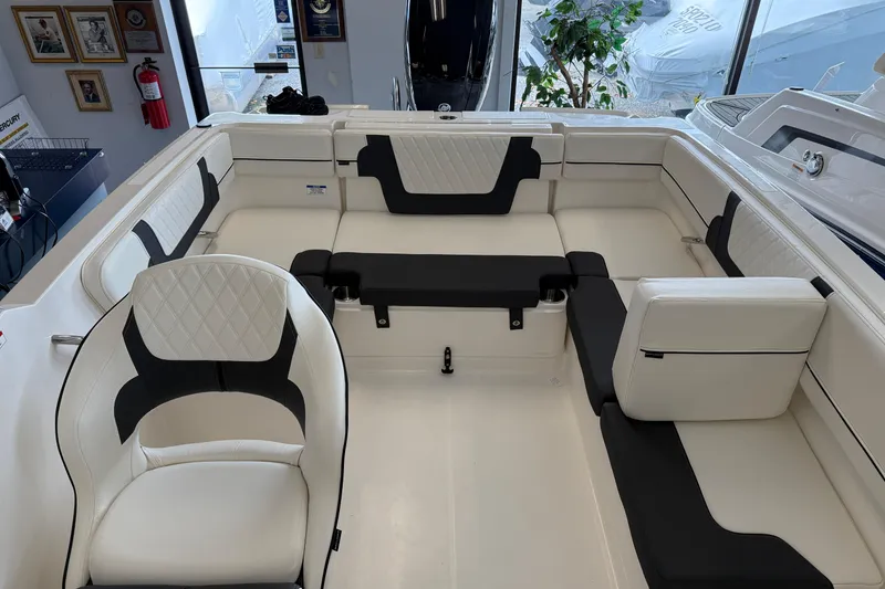 Slide: The Image of 2025 Bayliner VR4 Bowrider OB interior with white and black seating, showroom display. - 12