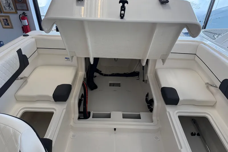 Slide: The Image of 2025 Bayliner VR4 Bowrider OB interior with open storage compartments and seating. - 13