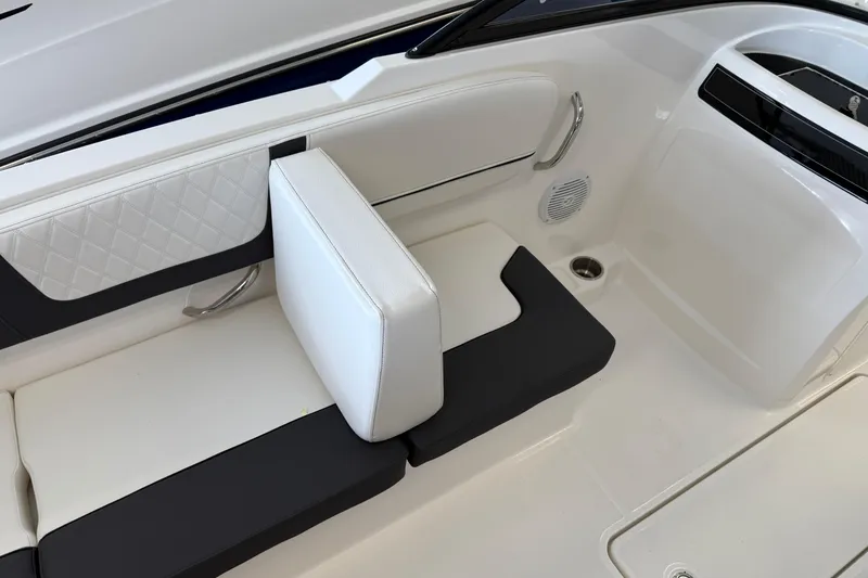 Slide: The Image of 2025 Bayliner VR4 Bowrider OB interior seating with white and black upholstery. - 4