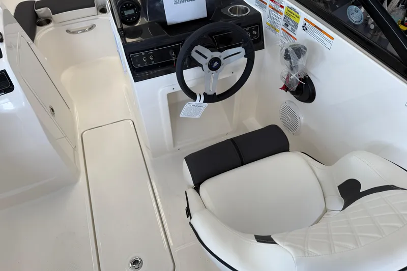 Slide: The Image of 2025 Bayliner VR4 Bowrider OB interior with steering wheel and seating. - 6