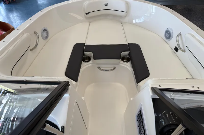 Slide: The Image of 2025 Bayliner VR4 Bowrider OB interior with cushioned seating and cup holders. - 8