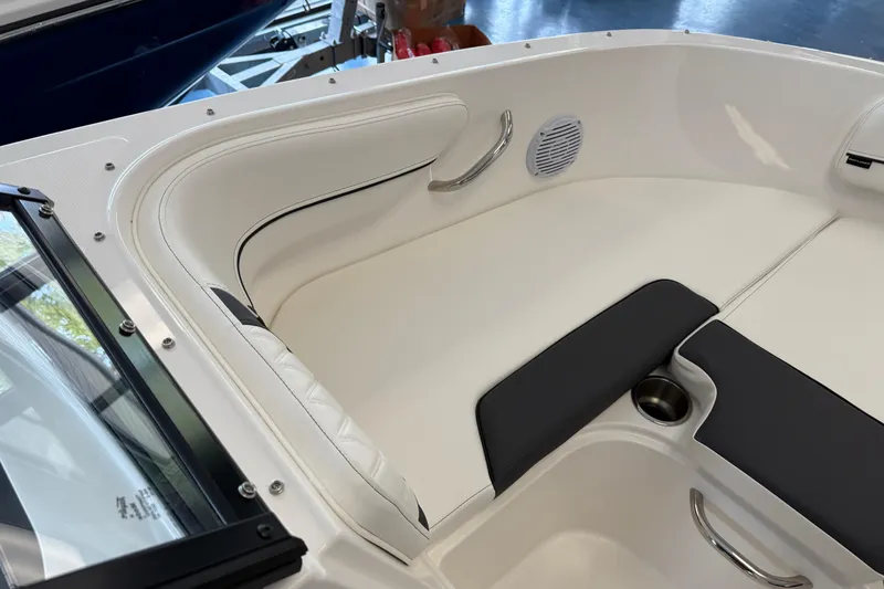 Slide: The Image of 2025 Bayliner VR4 Bowrider OB interior with white seating and stainless steel accents. - 9