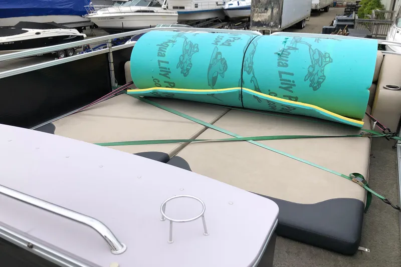 Slide: The Image of 2013 Avalon FUNSHIP 2485 boat with Aqua Lily Pad on deck, docked at marina. - 11