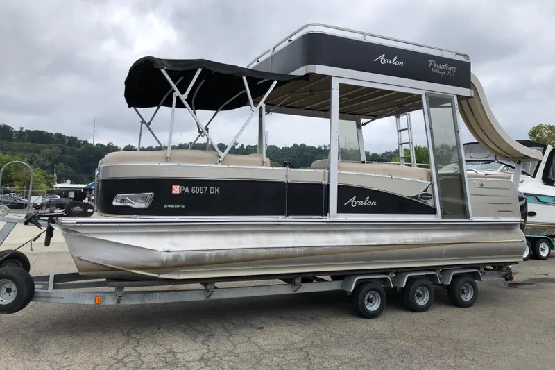Slide: The Image of 2013 Avalon FUNSHIP 2485 pontoon boat on trailer, featuring upper deck and slide. - 3