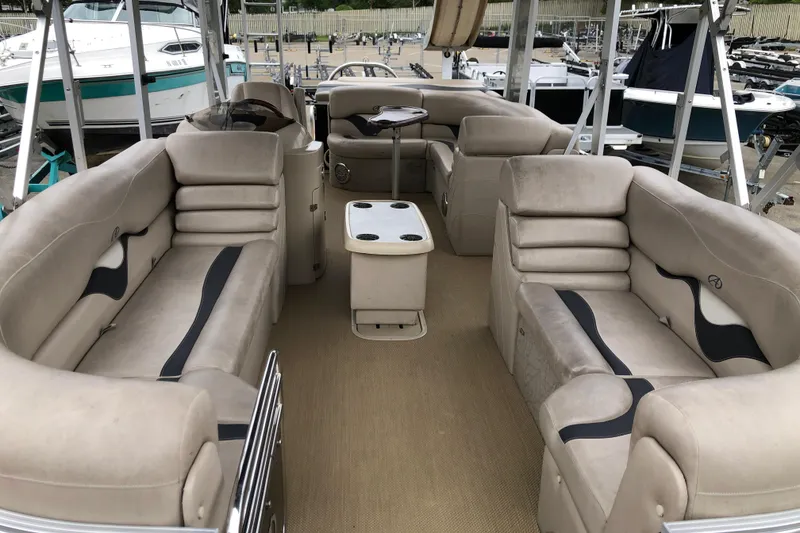 Slide: The Image of 2013 Avalon FUNSHIP 2485 pontoon boat interior with beige seating and table. - 4