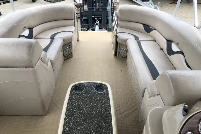 Slide: The Image of 2013 Avalon FUNSHIP 2485 pontoon boat interior with beige seating and black table. - 5