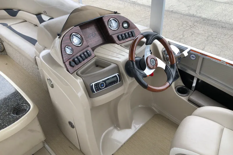 Slide: The Image of 2013 Avalon FUNSHIP 2485 boat interior with steering wheel and control panel. - 6