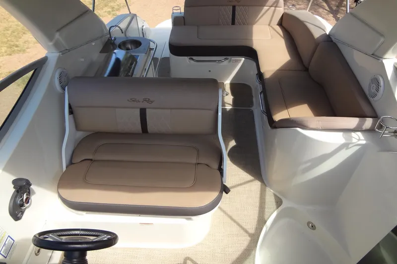 Slide: The Image of 2017 Sea Ray Sundancer 280 interior with beige seating and compact kitchenette. - 11