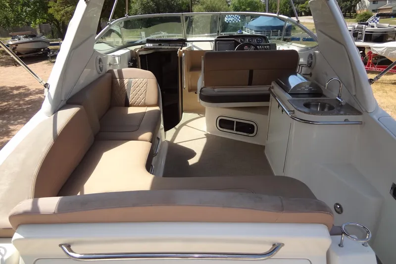 Slide: The Image of 2017 Sea Ray Sundancer 280 interior with seating and kitchenette. - 12