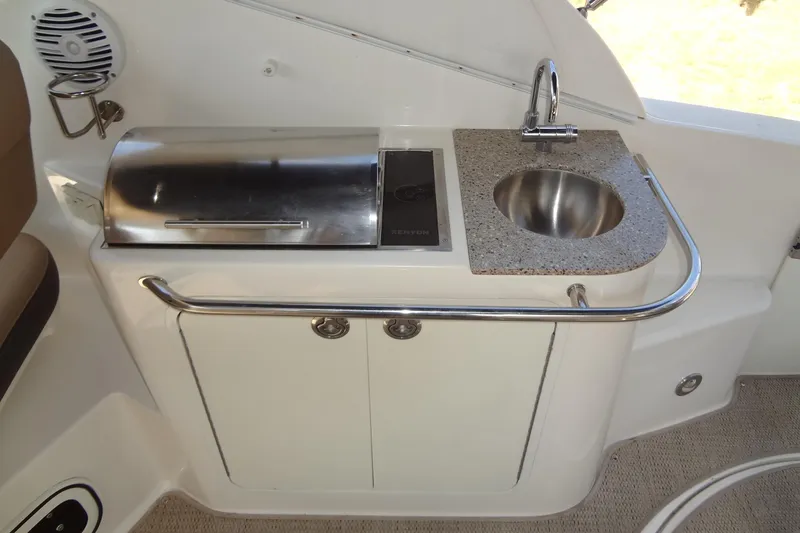 Slide: The Image of 2017 Sea Ray Sundancer 280 boat kitchenette with grill and sink. - 15