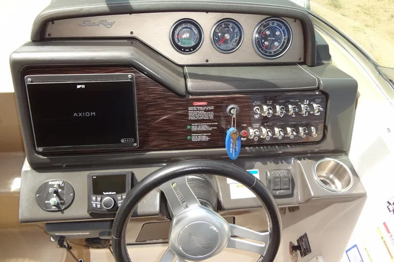 Slide: The Image of 2017 Sea Ray Sundancer 280 dashboard with controls, gauges, and Axiom display. - 20