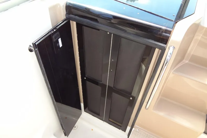 Slide: The Image of 2017 Sea Ray Sundancer 280 cabin door with sleek black finish and adjacent steps. - 26