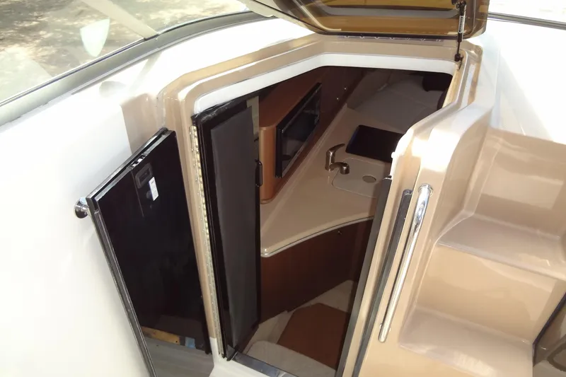 Slide: The Image of 2017 Sea Ray Sundancer 280 cabin entrance with open door and visible interior. - 27