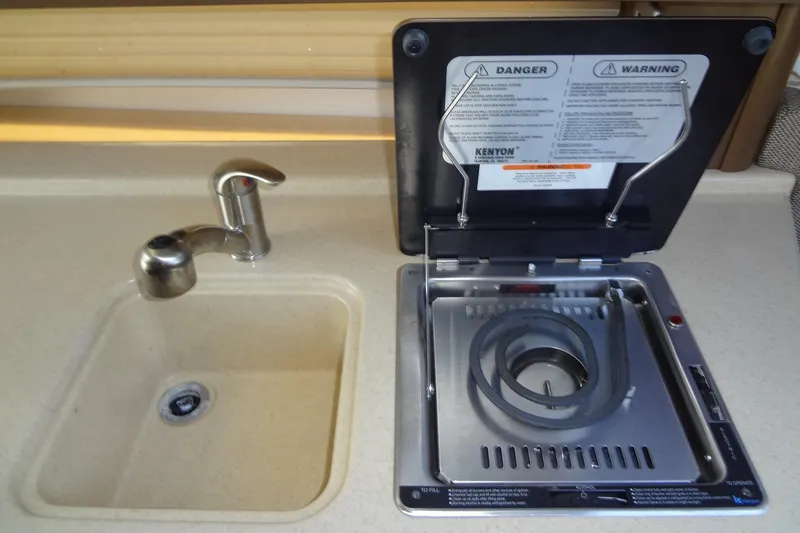 Slide: The Image of 2017 Sea Ray Sundancer 280 galley with sink and Kenyon stove. - 32