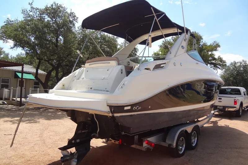 Slide: The Image of 2017 Sea Ray Sundancer 280 boat on trailer, parked outdoors under trees. - 4