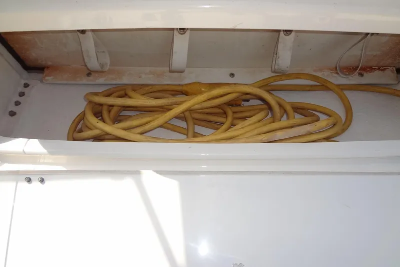 Slide: The Image of Storage compartment with yellow cable on 2017 Sea Ray Sundancer 280 boat. - 41
