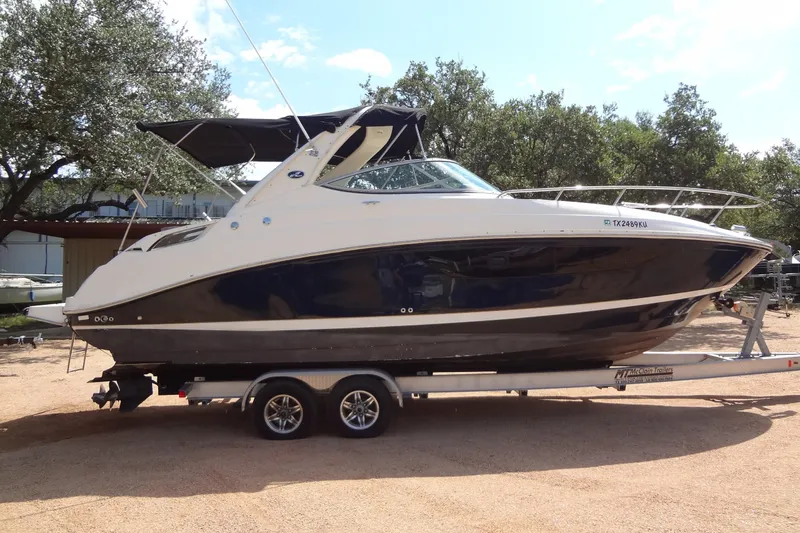 Slide: The Image of 2017 Sea Ray Sundancer 280 boat on trailer, parked outdoors under trees. - 5