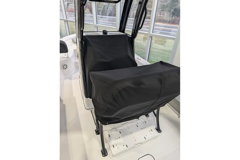 Slide: The Image of 2026 Sportsman Masters 227 Bay Boat interior with covered console and seating. - 12