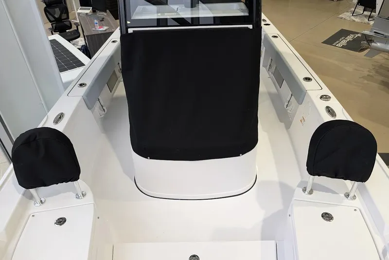 Slide: The Image of 2026 Sportsman Masters 227 Bay Boat interior with black seat covers and modern design. - 13