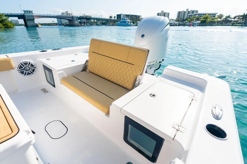 Slide: The Image of 2026 Sportsman Masters 227 Bay Boat with sleek seating and modern design at a marina. - 8