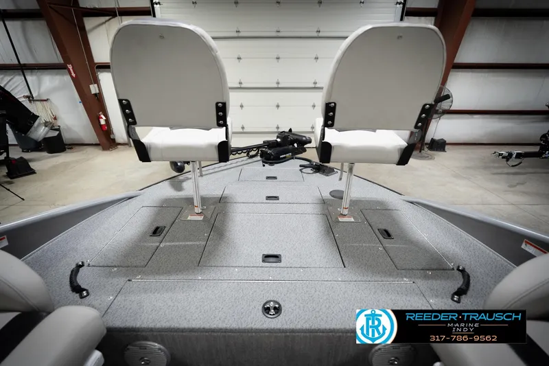 Slide: The Image of Fishing boat interior with two swivel seats, storage compartments, and Reeder-Trausch Marine logo. - 16