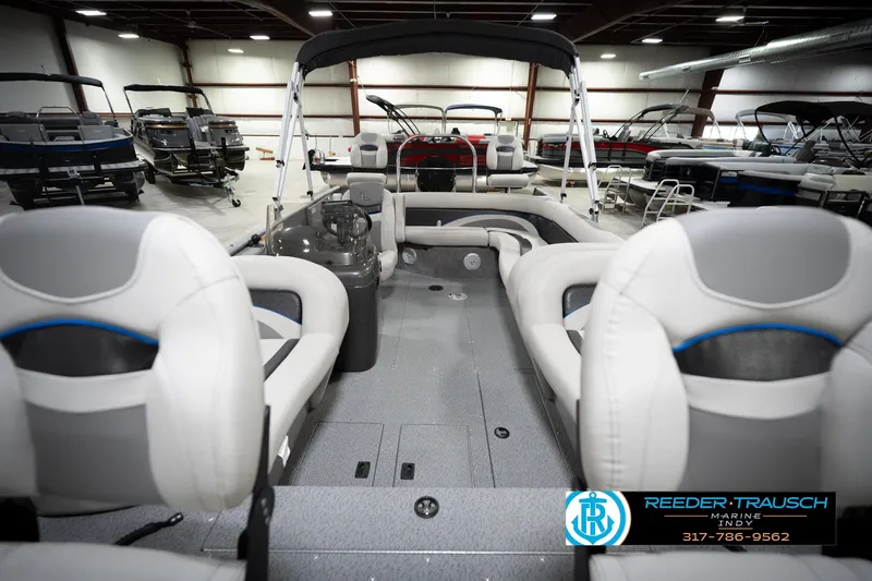 Slide: The Image of Interior view of a 2022 Flowers SD224 boat in a showroom, featuring plush seating. - 17