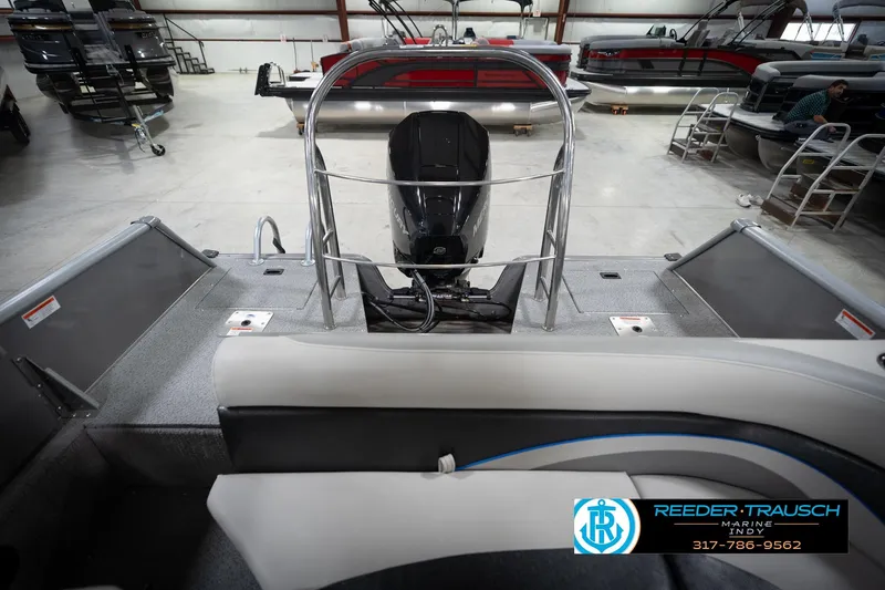 Slide: The Image of Interior view of a 2022 Flowers SD224 boat in a showroom with seating and motor. - 20