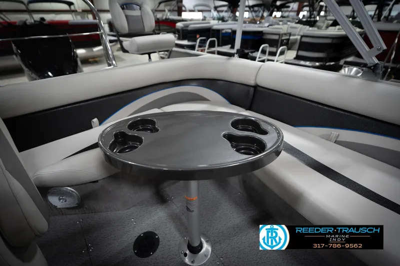 Slide: The Image of Interior of a 2022 Flowers SD224 boat with seating and a cupholder table. - 23