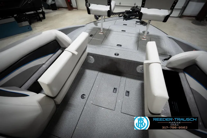 Slide: The Image of Modern boat interior with gray seating and storage compartments, featuring Reeder-Trausch Marine branding. - 25