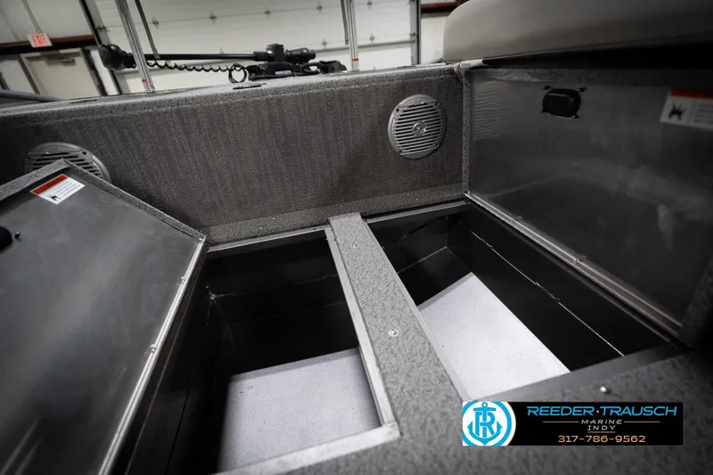 Slide: The Image of Interior view of a 2022 Flowers SD224 boat storage compartments with speaker and branding. - 27