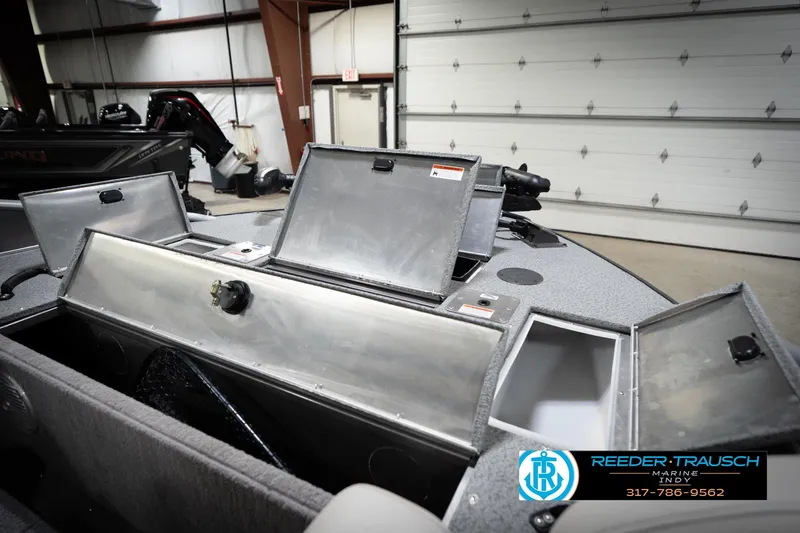 Slide: The Image of Open storage compartments on a 2022 Flowers SD224 boat in a garage setting. - 30
