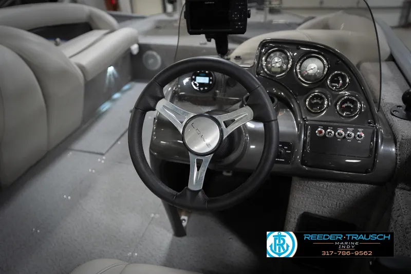 Slide: The Image of Interior of a 2022 Flowers SD224 boat with steering wheel and dashboard controls. - 31