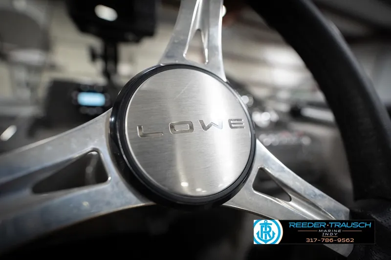 Slide: The Image of Close-up of a Lowe boat steering wheel with Reeder-Trausch Marine logo. - 33