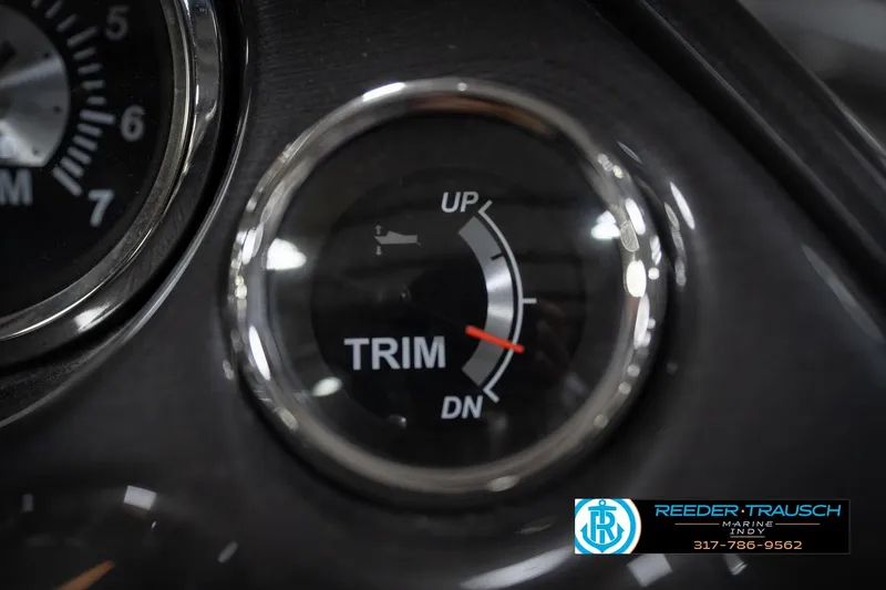 Slide: The Image of Close-up of a boat trim gauge with Reeder-Trausch Marine logo. - 38