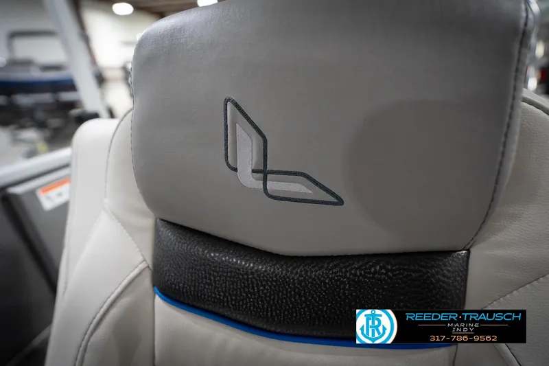 Slide: The Image of Gray leather seat with embroidered logo, featuring Reeder-Trausch Marine branding. - 43
