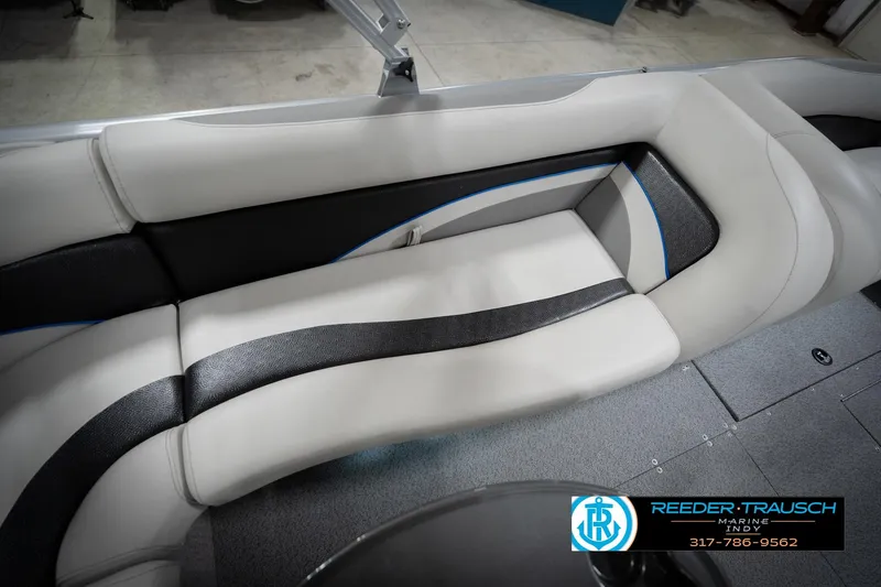 Slide: The Image of Luxurious boat seating with black and white upholstery, featuring Reeder Trausch Marine branding. - 45