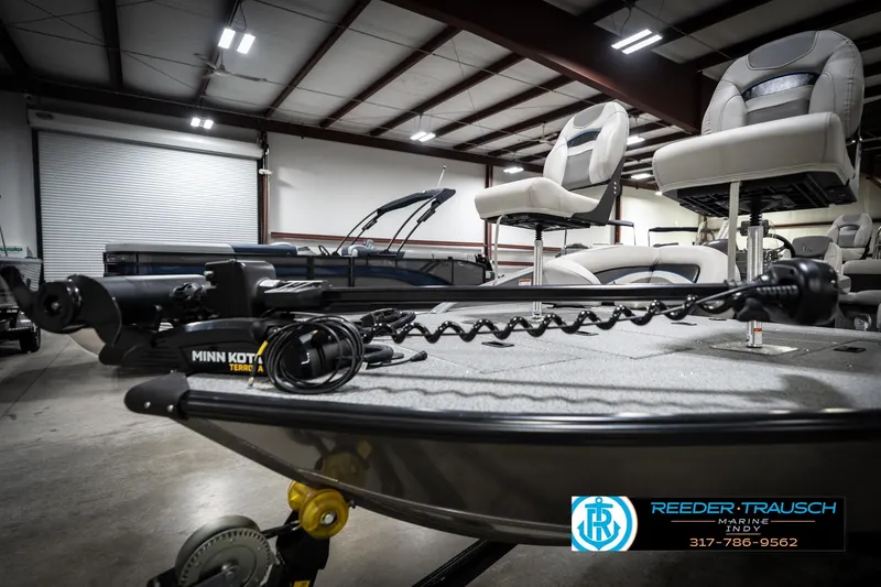 Slide: The Image of Boat interior with Minn Kota trolling motor, swivel seats, and Reeder-Trausch Marine logo. - 48